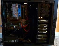 Insides of the home server showing large cpu cooler and several hard drives